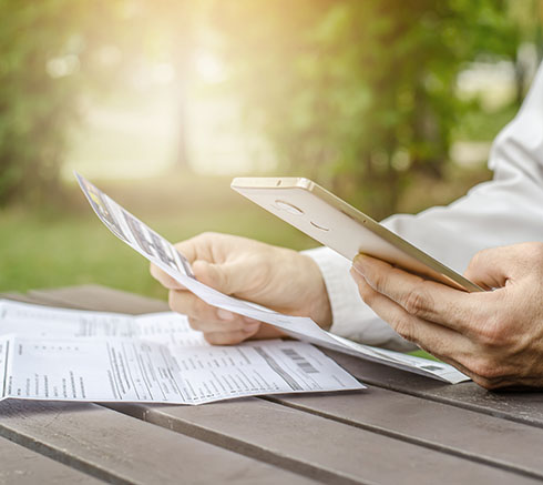 Man using calculator and thinking about cost with paying bills