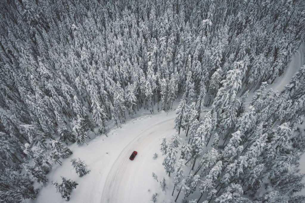 Aerial view of a car driving through the Mt Hood National Forest, Oregon.