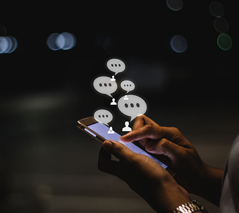 Businesswoman using smartphone at night in the city ,social, med