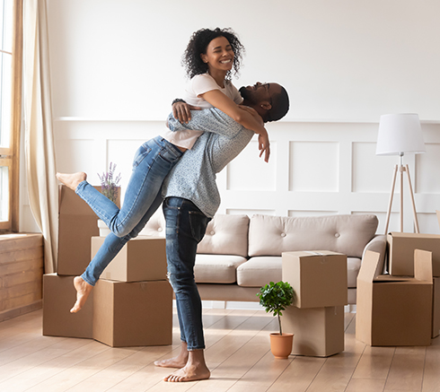 Happy african couple first time home buyers celebrate moving day