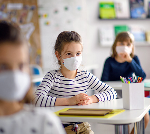 Children with face mask back at school after covid-19 quarantine and lockdown.