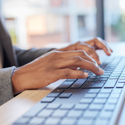 Hands typing on a keyboard