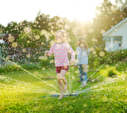 Kids playing in sprinkler