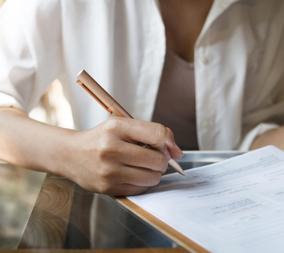 women signing documents